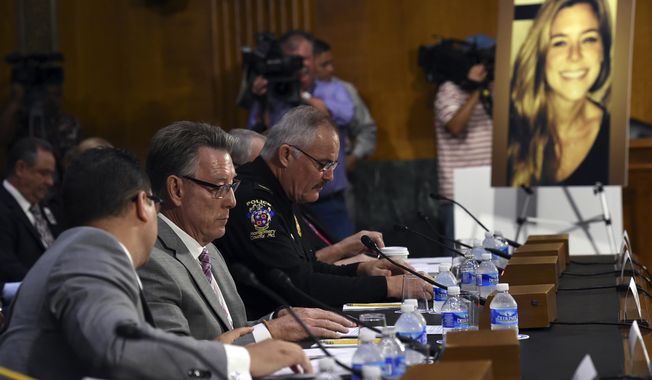 Jim Steinle, second from left, father of Kathryn Steinle, in photograph, testifies next to Montgomery County (Md.) Police Department. Chief J. Thomas Manger, right, before a Senate Judiciary hearing to examine the Administration&#x27;s immigration enforcement policies, in Washington, Tuesday, July 21, 2015. Kathryn Steinle was killed on a San Francisco pier, allegedly by a man previously deported several times. (AP Photo/Molly Riley)