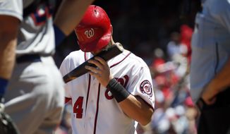 Washington Nationals right fielder Bryce Harper (34) kisses his bat as he prepares to bat during a baseball game against the New York Mets at Nationals Park, Wednesday, July 22, 2015, in Washington. (AP Photo/Alex Brandon)