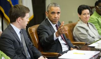 President Obama (center), with Paul Sullivan (left), vice president of international business development at Acrow Bridge, and Susan Jaime, CEO Ferra Coffee International, gestures during his meeting with small-business owners to discuss the importance of the reauthorization of the Export-Import Bank in the Roosevelt Room of the White House on July 22, 2015. (Associated Press)