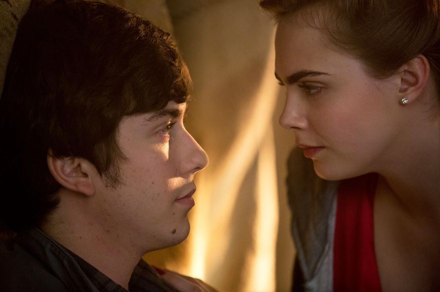 This photo provided by Twentieth Century Fox shows, Cara Delevingne, right, as Margo, and Nat Wolff as Quentin, in a scene from the film, "Paper Towns." (Michael Tackett/Twentieth Century Fox via AP)