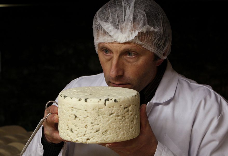 FILE - In this Wednesday, Jan. 21, 2009 file photo, Bernard Roques checks a Roquefort cheese as it matures in a cellar in Roquefort, southwestern France. On Thursday, July 23, 2015, researchers at Purdue University announced findings that show people have a distinct and basic taste for fat, and propose expanding the taste palate to include it along with sweet, salty, bitter, sour and relative newcomer umami. (AP Photo/Bob Edme)