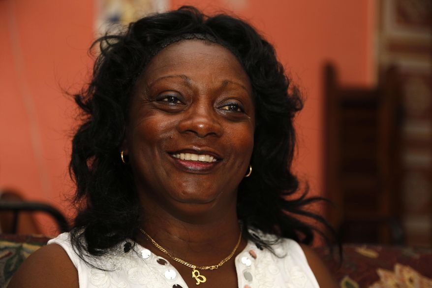In this July 6, 2015 photo, the leader of a faction of the Ladies in White, Berta Soler, speaks during an interview in the dissident group's headquarters, in Havana, Cuba. "The only thing they want is to open up business, the embassy," said Soler. "Whenever someone high-level came from the United States before, they always had time to meet with us before getting on the plane (back home), and that's not happening." (AP Photo/Desmond Boylan)