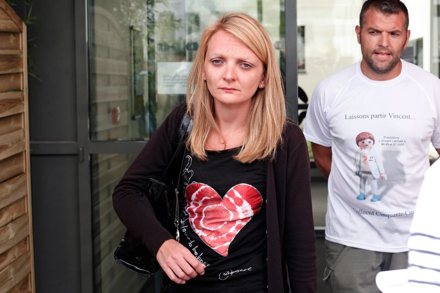 Rachel Lambert, wife of Vincent Lambert, cries as she delivers a speech to the media, at the Sebastopol hospital, in Reims, eastern France, where Vincent, who is currently on artificial life support, is hospitalized, Thursday, July 23, 2015. Vincent Lambert was left comatose in a 2008 car accident. His wife wants doctors to stop life support but his parents disagree. Lambert's parents say his doctors made no decision Thursday on his care but asked for a legal representative to be designated and sought protection against threats against him and his medical team. (AP Photo/Thibault Camus)