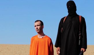 Islamic State police enforce the group&#39;s strict interpretation of Shariah law. Use of brutality such as the grisly death of Briton David Haines subjugates people to authoritarian order. (Associated Press) ** FILE **