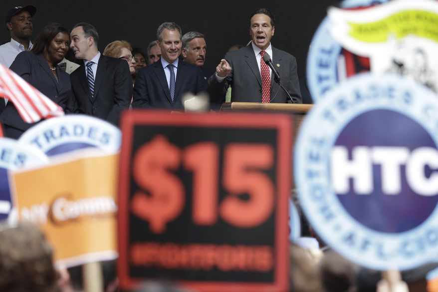 New York Gov. Andrew Cuomo speaks during a rally after the New York Wage Board endorsed a proposal to set a $15 minimum wage for workers at fast-food restaurants with 30 or more locations, Wednesday, July 22, 2015 in New York. The increase would be phased in over three years in New York City and over six years elsewhere. (AP Photo/Mary Altaffer)
