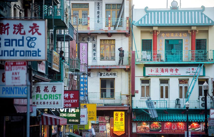 In this June 4, 2015 photo, small businesses' signs line Waverly Place in San Francisco's Chinatown. The country's oldest Chinatown has sheltered immigrants for more than 100 years, but may face changes as San Francisco undergoes an unprecedented boom in technology jobs. (AP Photo/Noah Berger)