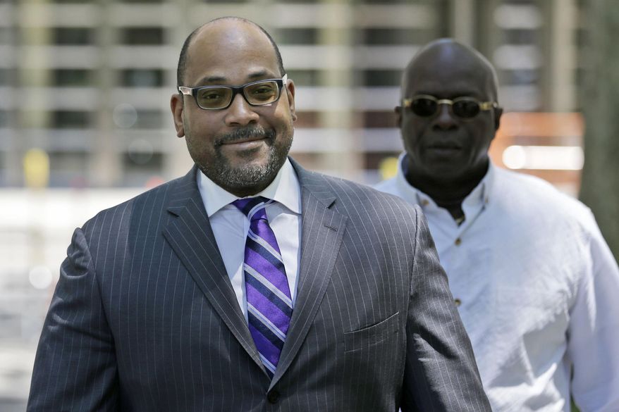 FILE - This June 22, 2015 file photo shows New York state Sen. John Sampson, left, as he leaves federal court after jury selection in his obstruction of justice trial, in the Brooklyn borough of New York. Sampson was convicted Friday, July 24, 2015, on charges he lied to the FBI in an attempt to obstruct a corruption investigation targeting him for embezzlement. (AP Photo/Seth Wenig, File)