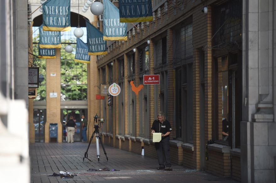 The Ann Arbor Police Department investigates a scene after a 21-year-old University of Michigan student fell through the glass ceiling and died at Ann Arbor's Nickels Arcade in Ann Arbor, Mich., on Friday, July 24, 2015. (Melanie Maxwell /The Ann Arbor News via AP) LOCAL TELEVISION OUT; LOCAL INTERNET OUT; MANDATORY CREDIT