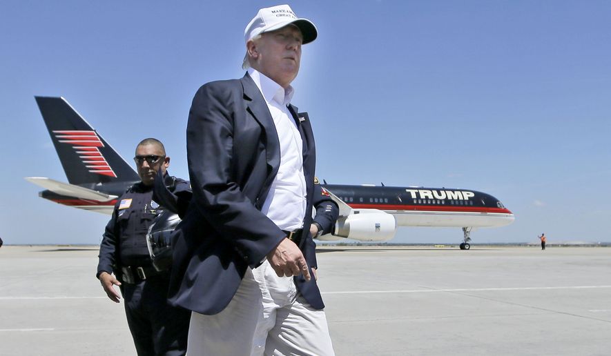 Republican presidential hopeful Donald Trump walks the tarmac before boarding his campaign plane to depart from Laredo, Texas, on July 23, 2015. (Associated Press) ** FILE **