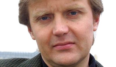 In this Friday, May 10, 2002, file photo, Alexander Litvinenko, former KGB spy and author of the book &quot;Blowing Up Russia: Terror From Within&quot; is photographed at his home in London. A prime suspect in the killing of Alexander Litvinenko says he won&#39;t testify as planned at an inquiry into the former Russian spy&#39;s death, leading the judge in charge to accuse him of trying to manipulate proceedings.  (AP Photo/Alistair Fuller, File)