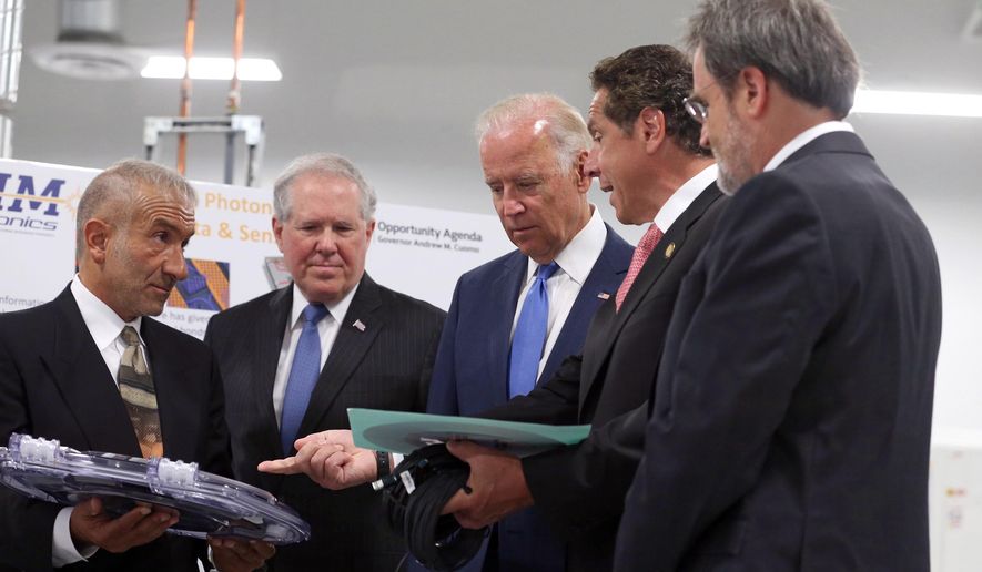 New York Governor Andrew Cuomo asks Dr. Alain Kaloyeros, founding President and CEO of SUNY Polytechnic Institute, left, a question during a briefing for Vice President Joe Biden, center, and Under secretary Frank Kendall, as they visit SUNY Poly Canal Ponds during the official announcement of the Department of Defense awarding a $110 million to help create the new American Institute for Manufacturing Integrated Photonics Monday, July 27, in Rochester, NY. At right is Michael Liehr, Executive Vice President of Innovation and Technology, Colleges of Nanoscale Science and Engineering, SUNY Polytechnic Institute. (Shawn Dowd/Democrat & Chronicle via AP)