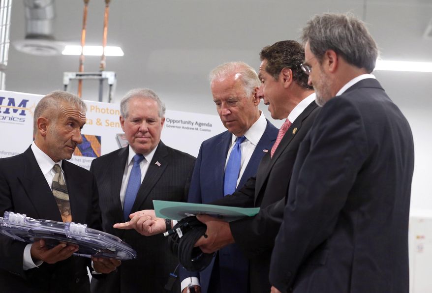New York Governor Andrew Cuomo asks Dr. Alain Kaloyeros, founding President and CEO of SUNY Polytechnic Institute, left, a question during a briefing for Vice President Joe Biden, center, and Under secretary Frank Kendall, as they visit SUNY Poly Canal Ponds during the official announcement of the Department of Defense awarding a $110 million to help create the new American Institute for Manufacturing Integrated Photonics Monday, July 27, in Rochester, NY. At right is Michael Liehr, Executive Vice President of Innovation and Technology, Colleges of Nanoscale Science and Engineering, SUNY Polytechnic Institute. (Shawn Dowd/Democrat & Chronicle via AP)