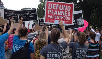 Pro-life activists call for the defunding of Planned Parenthood at a rally at the U.S. Capitol on July 28, 2015. (Cheryl Wetzstein/The Washington Times)