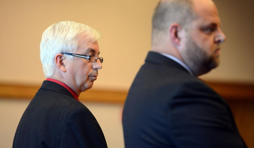 Rep. Steve Kraus, R-Sandusky, left, and his attorney Troy Murphy, right, listen as a jury returns verdicts at the Ottawa County Courthouse, Monday, July 27, 2015, in Port Clinton, Ohio. Kraus, accused of stealing antiques and other items from a home while doing work as an auctioneer, has been convicted on a felony theft charge and immediately removed from office under state law. (Jason Werling/The Sandusky Register via AP)