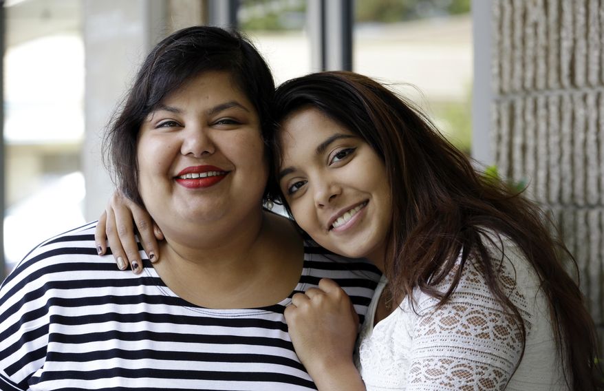 In this photo taken Thursday, July 23, 2015, Anjana Agarwal, left, poses with a photo with her daughter Aanya Nigam, 16, in Issaquah, Wash. After using an Internet-connected Amazon Echo digital assistant for two months, Aanya, 16, started to worry that the device was eavesdropping on conversations in her living room. So she unplugged the device and hid it in a place that her mother still hasn’t been able to find. (AP Photo/Elaine Thompson)