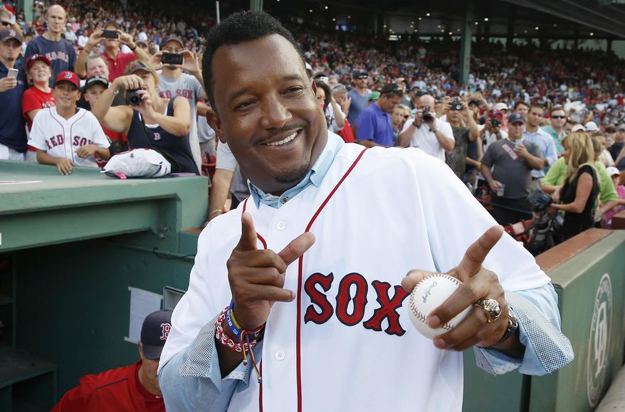 Former Boston Red Sox great Pedro Martinez gestures as he leaves the field following a ceremony conducted in Spanish to honor him after his induction into the Baseball Hall of Fame, before a baseball game between the Red Sox and the Chicago White Sox in Boston, Wednesday, July 29, 2015. (AP Photo/Michael Dwyer) ** FILE **