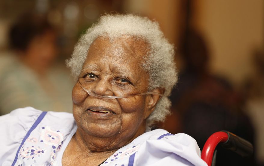 Bernice Williams, poses for a photograph as she celebrates her 103rd birthday on Saturday, July 25, 2015 in Dallas. She is known locally as Ms. Boots. She got her nickname 103 years ago, when she was a baby. Her mother brought her along as she did housework for a rich white family. She'd leave her in an apple crate for the family's children to watch over. They started calling her Boots, and it stuck. (Michael Ainsworth/The Dallas Morning News via AP) MANDATORY CREDIT; MAGS OUT; TV OUT; INTERNET USE BY AP MEMBERS ONLY; NO SALES