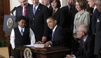 FILE - In this March 23, 2010, file photo, President Barack Obama reaches for a pen to sign the health care bill in the East Room of the White House in Washington. Nonprofit co-ops, the health care law’s public-spirited alternative to mega insurers, are awash in red ink and many have fallen short of sign-up goals, a government audit has found. (AP Photo/Charles Dharapak, File)