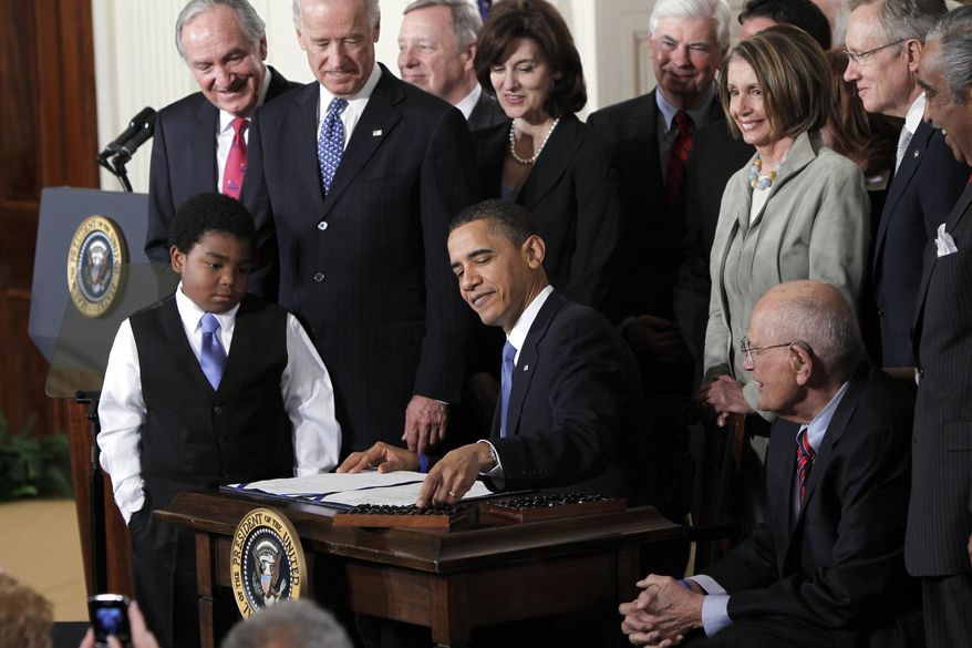 FILE - In this March 23, 2010, file photo, President Barack Obama reaches for a pen to sign the health care bill in the East Room of the White House in Washington. Nonprofit co-ops, the health care law’s public-spirited alternative to mega insurers, are awash in red ink and many have fallen short of sign-up goals, a government audit has found. (AP Photo/Charles Dharapak, File)