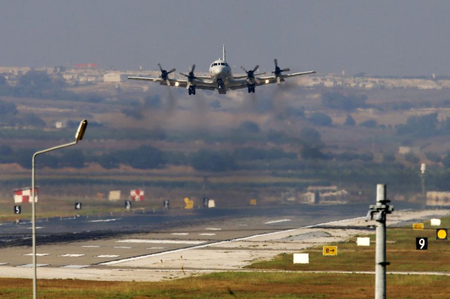 A United States Navy aeroplane about to land at the Incirlik Air Base, in the outskirts of the city of Adana, southern Turkey, Wednesday, July 29, 2015. Turkish Foreign Ministry spokesman Tanju Bilgic said Wednesday, that an agreement allowing the U.S.-led coalition against the IS to launch airstrikes from Incirlik and other Turkish bases has been approved by Cabinet. Coalition forces could start using the bases “any moment,” Bilgic said. (AP Photo/Emrah Gurel)