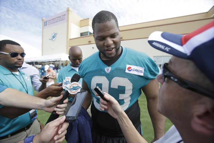Miami Dolphins defensive tackle Ndamukong Suh speaks to members of the media after the teams NFL football training camp, Thursday, July 30, 2015, in Davie, Fla. (AP Photo/Wilfredo Lee)
