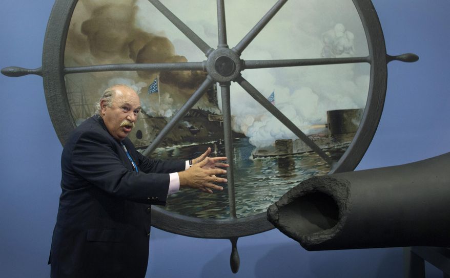 In this Tuesday, July 28, 2015 photo, John V. Quarstein, with the USS Monitor Foundation, gives a tour about the Monitor and the CSS Virginia at The Mariners’ Museum in Newport News, Va. Conservators drained the Monitor gun turret for the first time in more than three years. The Union's Monitor sank during the Civil War in 1862 and its wreckage was found in 1973. (L. Todd Spencer/The Virginian-Pilot via AP) MAGS OUT; MANDATORY CREDIT