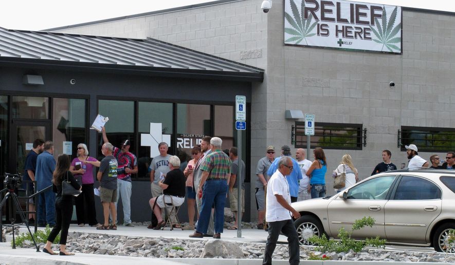 Dozens of people line up outside the Silver State Relief medical marijuana dispensary in Sparks, Nev., Friday, July 31, 2015, to be among the first in Nevada to legally purchase medicinal pot. (AP Photo/Scott Sonner)