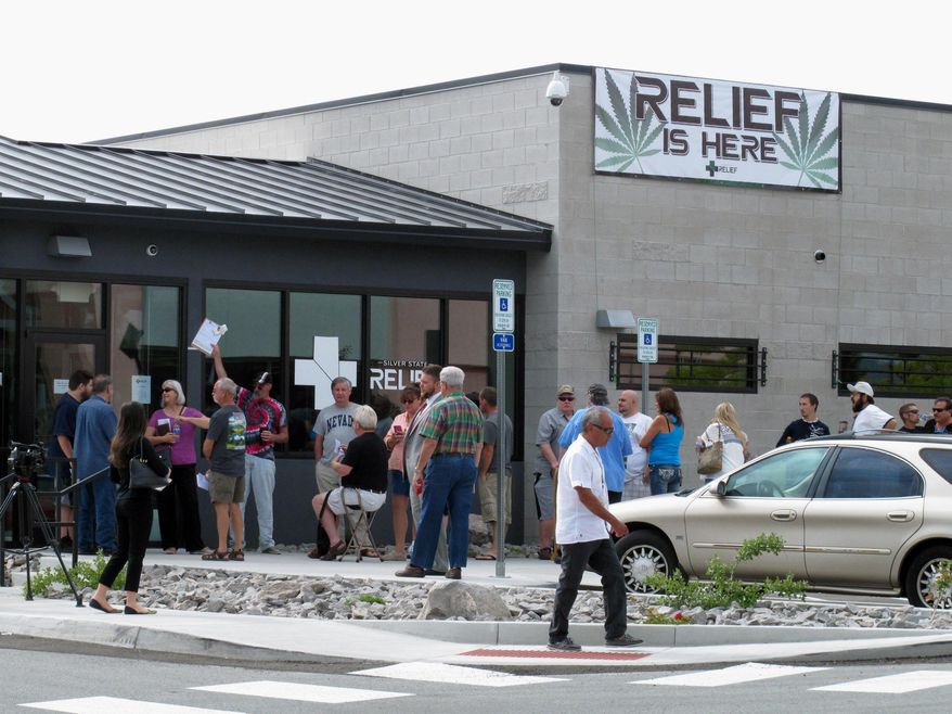 Dozens of people line up outside the Silver State Relief medical marijuana dispensary in Sparks, Nev., Friday, July 31, 2015, to be among the first in Nevada to legally purchase medicinal pot. (AP Photo/Scott Sonner)