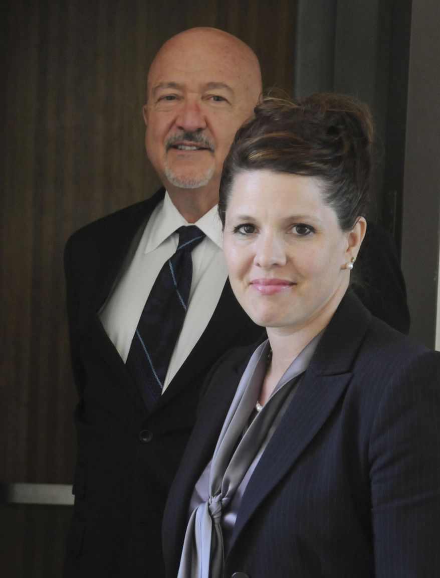 FILE - In this May 21, 2015 file photo, former Republican political candidate Annette Bosworth stands with one of her attorneys Dana Hanna during a break in her trial in Pierre, S.D. Bosworth, who was found guilty of six counts each of perjury and filing false documents, is undergoing proceedings that started Friday, July 31, 2015, to determine if her medical license should be revoked after her felony conviction for election law violations in May. (AP Photo/James Nord, File)