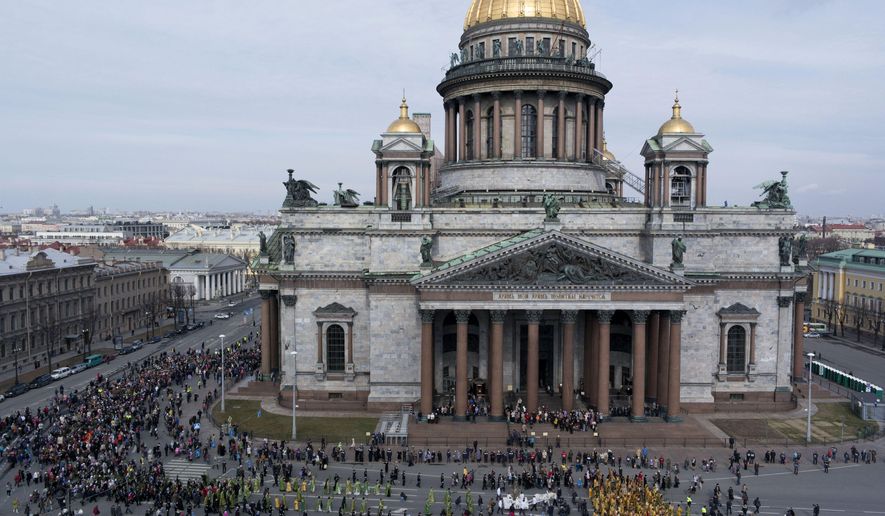 FILE - In this file aerial photo taken on Sunday, April 13, 2014, Orthodox priests and believers participate in the Palm Sunday procession around the St. Isaak's Cathedral in St. Petersburg, Russia. The Russian Orthodox Church on Friday defended its controversial bid to fully take over St. Petersburg's landmark St. Isaac's Cathedral, saying it's in line with the law and wouldn't hamper tourist access. (AP Photo/Dmitry Lovetsky, file)