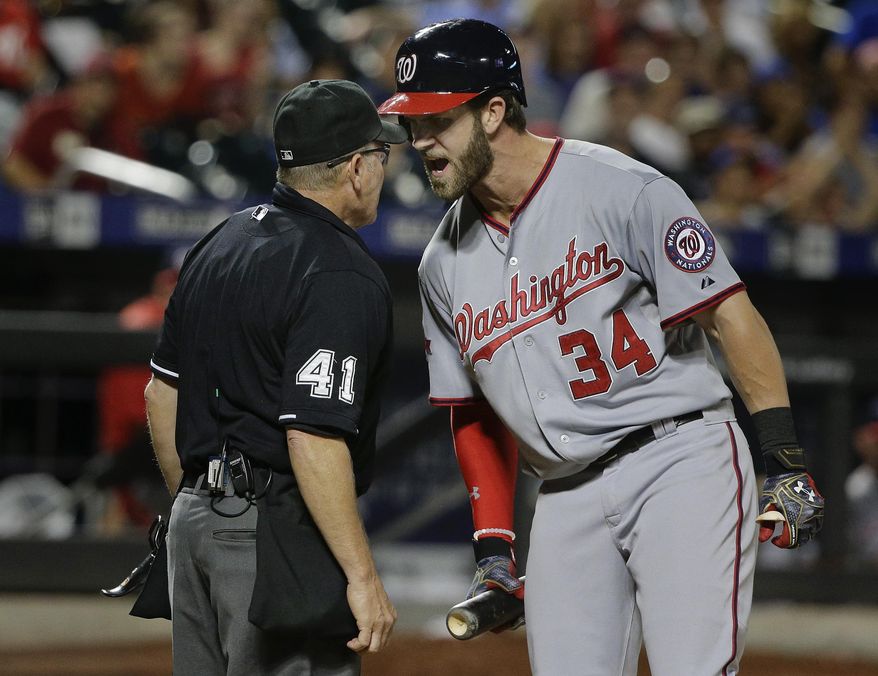 Washington Nationals&#39; Bryce Harper (34) argues with home plate umpire Jerry Meals (41) after striking out during the eleventh inning of a baseball game against the New York Mets, Friday, July 31, 2015, in New York. (AP Photo/Julie Jacobson)