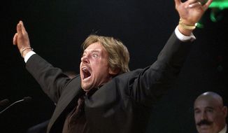 Wrestler Rowdy Roddy Piper gestures to the crowd after being inducted into the WWE Hall of Fame at the Induction Ceremony in Universal City, Calif., in this April 2, 2005, file photo. The WWE said Piper died Friday, July 31, 2015. He was 61. (AP Photo/Matt Sayles, File)