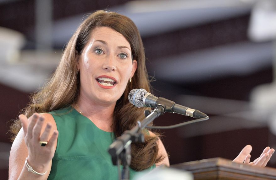Kentucky democratic candidate for Secretary of State Alison Lundergan Grimes speaks to the crowd at the Fancy Farm Picnic in Fancy Farm, Ky., Saturday, Aug. 1, 2015. The picnic, where party lines are split down the middle of the picnic pavilion is a must attend event for candidates for statewide office. (AP Photo/Timothy D. Easley)