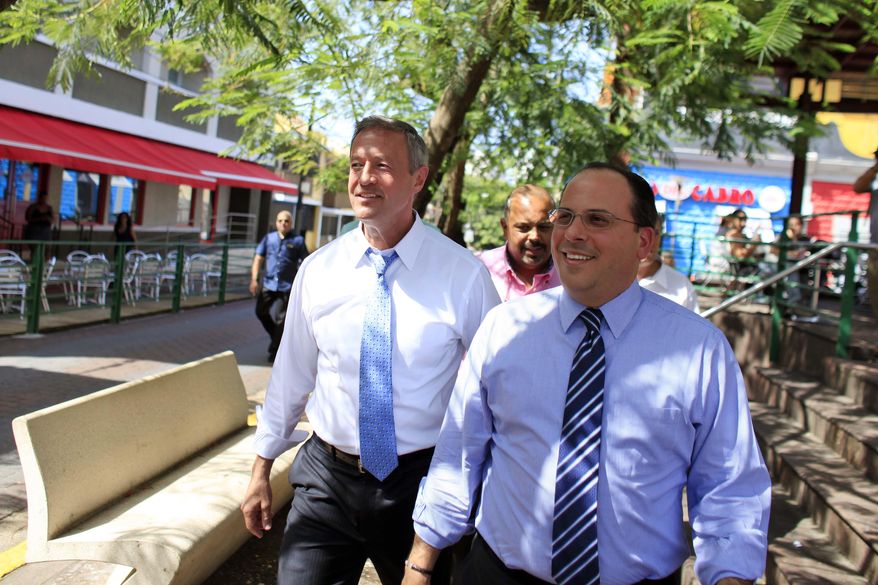 Democratic presidential candidate, former Maryland Gov. Martin O'Malley, left, walks with Jaime Perello, speaker of Puerto Rico’s House of Representatives during a campaign stop in San Juan, Puerto Rico, Saturday, Aug. 1, 2015. O’Malley is the first Democratic candidate to campaign in Puerto Rico. (AP Photo/Ricardo Arduengo)