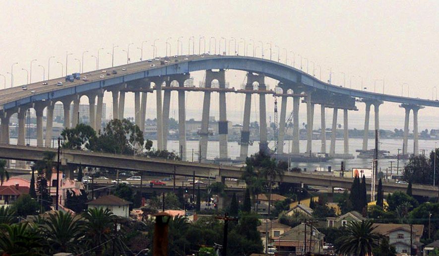 FILE - This Nov. 2, 2001 file photo shows the Coronado Bridge linking San Diego with Coronado Island. A coalition of San Diego residents is studying the feasibility of a barrier to prevent suicides on the city's iconic Coronado Bridge. Since the bridge to popular Coronado Island opened in 1969, about 300 people have committed suicide there, jumping from the 200-foot span and into San Diego Bay.(AP Photo/Fred Greaves, File)