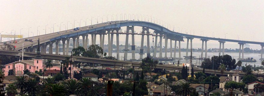 FILE - This Nov. 2, 2001 file photo shows the Coronado Bridge linking San Diego with Coronado Island. A coalition of San Diego residents is studying the feasibility of a barrier to prevent suicides on the city's iconic Coronado Bridge. Since the bridge to popular Coronado Island opened in 1969, about 300 people have committed suicide there, jumping from the 200-foot span and into San Diego Bay.(AP Photo/Fred Greaves, File)