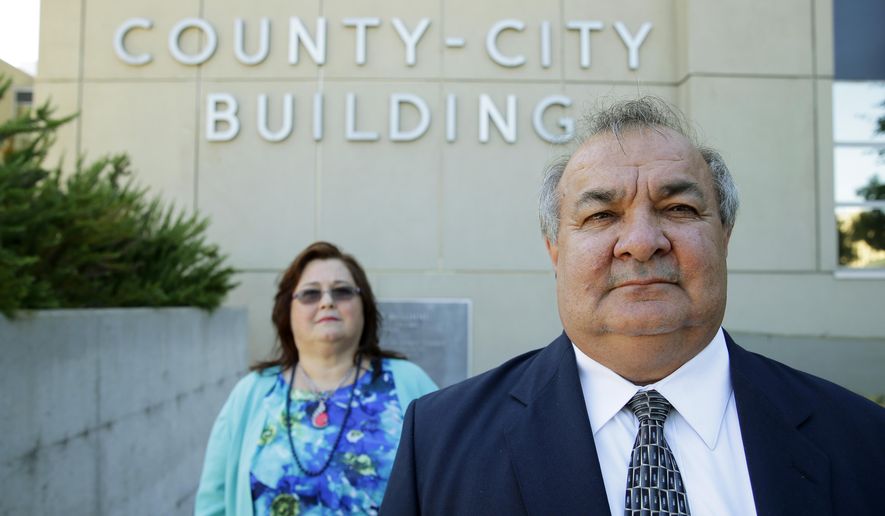 In this July 2, 2015 photo, Steve Marrival, right, poses for a photo with his wife, Carolyn Merrival, outside the County-City Building in Tacoma, Wash. Merrival, a deputy prosecuting attorney, has filed a whistleblower complaint with the state Attorney General’s office against county Prosecutor Mark Lindquist and a complaint with the Washington Bar Association against Lindquist and six deputy prosecutors. (AP Photo/Ted S. Warren)
