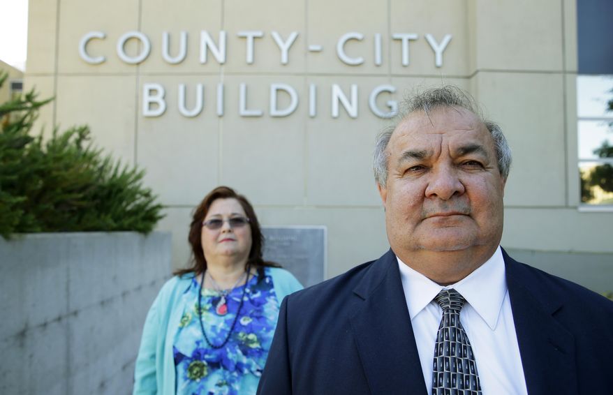 In this July 2, 2015 photo, Steve Marrival, right, poses for a photo with his wife, Carolyn Merrival, outside the County-City Building in Tacoma, Wash. Merrival, a deputy prosecuting attorney, has filed a whistleblower complaint with the state Attorney General’s office against county Prosecutor Mark Lindquist and a complaint with the Washington Bar Association against Lindquist and six deputy prosecutors. (AP Photo/Ted S. Warren)