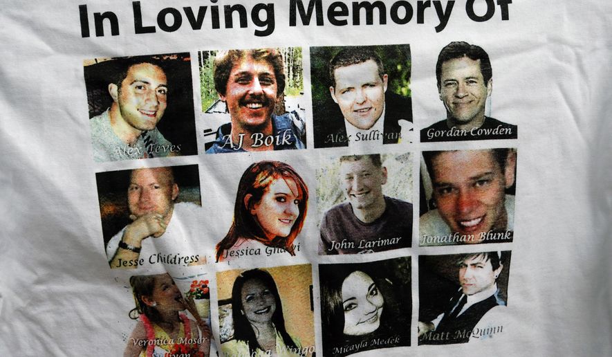 FILE - In this July 14, 2015, file photo, Sandy Phillips, whose daughter Jessica Ghawi was killed in the 2012 Aurora movie theatre massacre, displays a T-shirt memorializing the twelve people killed in the attack, outside the Arapahoe County District Court following the day of closing arguments in the trial of theater shootings defendant James Holmes, in Centennial, Colo. Their names are, left to right, top to bottom row: Alex Teves, AJ Boik, Alex Sullivan, Gordon Cowden, Jesse Childress, Jessica Ghawi, John Larimer, Jonathan Blunk, Veronica Moser-Sullivan, Rebecca Wingo, Micayla Medek, and Matt McQuinn. (AP Photo/Brennan Linsley, File)