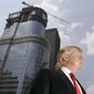 In this photo taken May 24, 2007, Donald Trump is profiled against his 92-story Trump International Hotel Tower during a news conference on construction progress in Chicago. (AP Photo/Charles Rex Arbogast, File)
