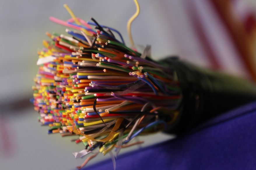 FILE - This July 9, 2015 file photo shows a bundle of insulated copper telephone cables during a news conference on copper and metal theft, at the Arkansas state Capitol in Little Rock, Ark. On Thursday, Aug. 6, 2015, the Federal Communications Commission is expected to require that phone companies warn residential customers three months before they abandon a copper network. For businesses, six months’ notice would be required. (AP Photo/Danny Johnston, File)
