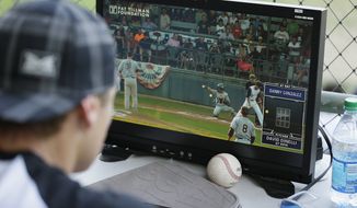 Former major league outfielder Eric Byrnes uses a computerized video system to call balls and strikes at an independent minor league baseball game between the San Rafael Pacifics and Vallejo Admirals Tuesday, July 28, 2015, in San Rafael, Calif. On Tuesday night, the computer system stood in for pitch calls in what is considered to be the first professional game without the umpire making those decisions. A full umpiring crew will be there for everything else. (AP Photo/Eric Risberg)