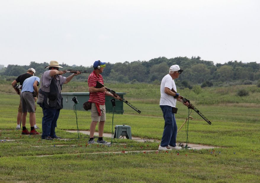 In this Wednesday, Aug. 5, 2015 photo, a squad of shooters participate in opening day competition at the Grand American World Trapshooting Tournament at the World Shooting and Recreation Complex in Sparta, Ill. The state of Illinois plans at the end of this month to close a money-losing shooting complex that regularly draws thousands each summer for the national competition. The Illinois Department of Natural Resources says it costs $3 million each year to operate the site, which brings in $1.1 million in annual revenue. (Les Winkeler/The Southern via AP) MANDATORY CREDIT