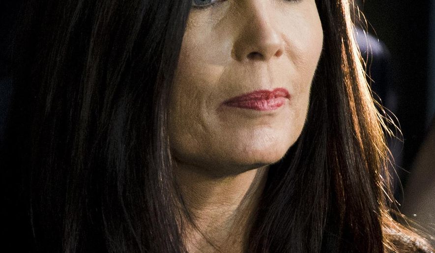FILE - In this March 11, 2015 file photo, Pennsylvania Attorney General Kathleen Kane walks from the State Supreme Court room at City Hall in Philadelphia. Kane spokesman Chuck Ardo said Thursday, Aug. 6, 2015, that Kane is aware of reports she faces criminal charges. A grand jury recommended in December that Kane be charged in connection with allegations she unlawfully leaked information from a 2009 investigation. (AP Photo/Matt Rourke, File)