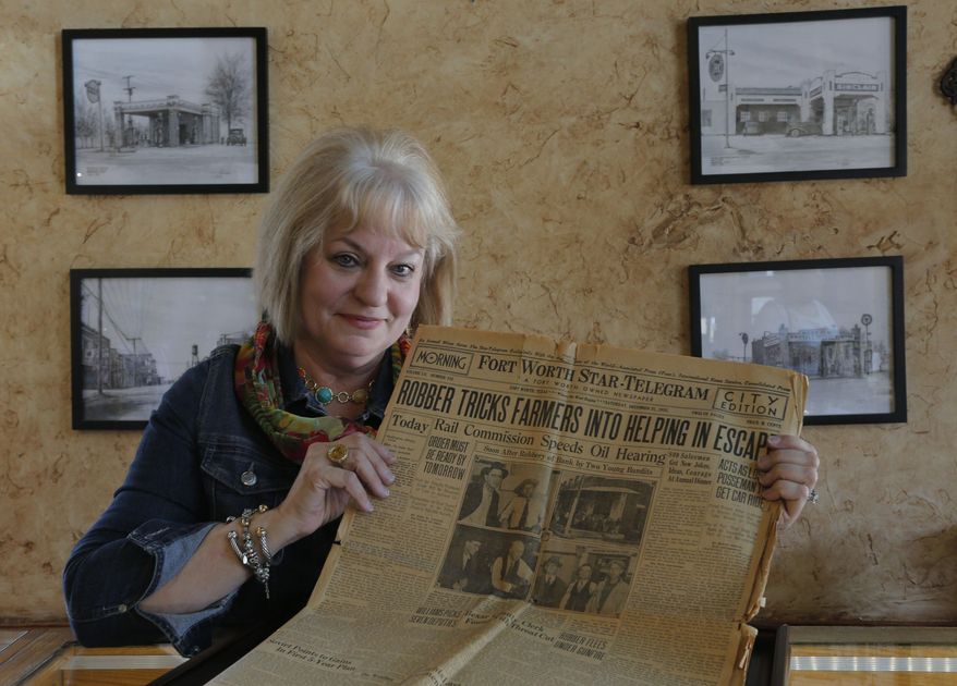 ADVANCE FOR USE SUNDAY, AUG. 9 - In this photo taken July 27, 2015, Debi Meek talks as she holds a newspaper a customer found on eBay with a story about by two Dallas crooks who were known associates of Bonnie and Clyde that robbed the bank where her Grapevine, Texas, business is now located. Although Bonnie Parker and Clyde Barrow were not involved in the robbery, Grapevine history aficionados have long had an interest in the couple because of their connection to the city, said Grapevine Mayor William D. Tate. (Rodger Mallison/Star-Telegram via AP) MAGS OUT; (FORT WORTH WEEKLY, 360 WEST); INTERNET OUT; MANDATORY CREDIT