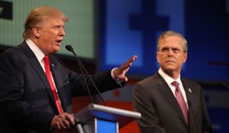 Republican presidential candidate Donald Trump, left, speaks as Jeb Bush listens during the first Republican presidential debate at the Quicken Loans Arena Thursday, Aug. 6, 2015, in Cleveland. (AP Photo/Andrew Harnik) ** FILE **