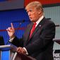 Republican presidential candidate Donald Trump speaks as Wisconsin Gov. Scott Walker listens during the first Republican presidential debate at the Quicken Loans Arena Thursday, Aug. 6, 2015, in Cleveland. (AP Photo/Andrew Harnik)
