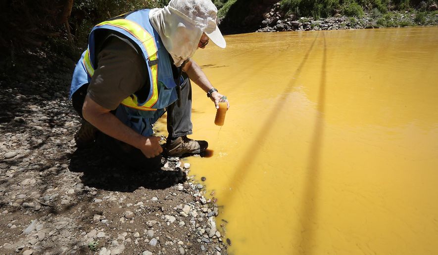Dan Bender, with the La Plata County Sheriff&#39;s Office, takes a water sample from the Animas River near Durango, Colo., Thursday, Aug. 6, 2015. The U.S. Environmental Protection Agency said that a cleanup team was working with heavy equipment Wednesday to secure an entrance to the Gold King Mine. Workers instead released an estimated 1 million gallons of mine waste into Cement Creek, which flows into the Animas River. (Jerry McBride/The Durango Herald via Associated Press) **FILE**