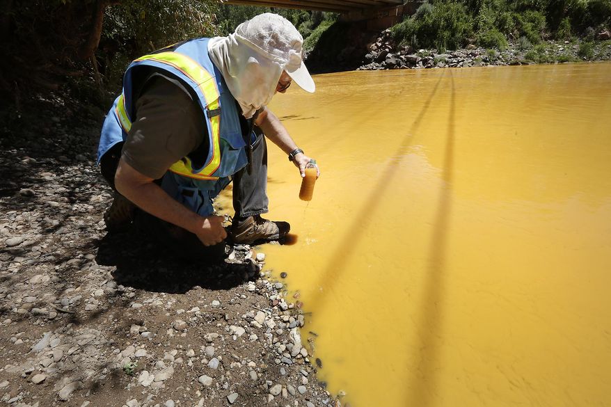 Dan Bender, with the La Plata County Sheriff&#39;s Office, takes a water sample from the Animas River near Durango, Colo., Thursday, Aug. 6, 2015. The U.S. Environmental Protection Agency said that a cleanup team was working with heavy equipment Wednesday to secure an entrance to the Gold King Mine. Workers instead released an estimated 1 million gallons of mine waste into Cement Creek, which flows into the Animas River. (Jerry McBride/The Durango Herald via Associated Press) **FILE**
