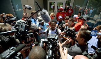 Kansas City Chiefs rookie running back LaVance Taylor is surrounded by the news media while giving an interview outside Scanlon Hall concluding an NFL football training camp practice, Friday, July 31, 2015, in St. Joseph, Mo. (Andrew Carpenean/The St. Joseph News-Press via AP)